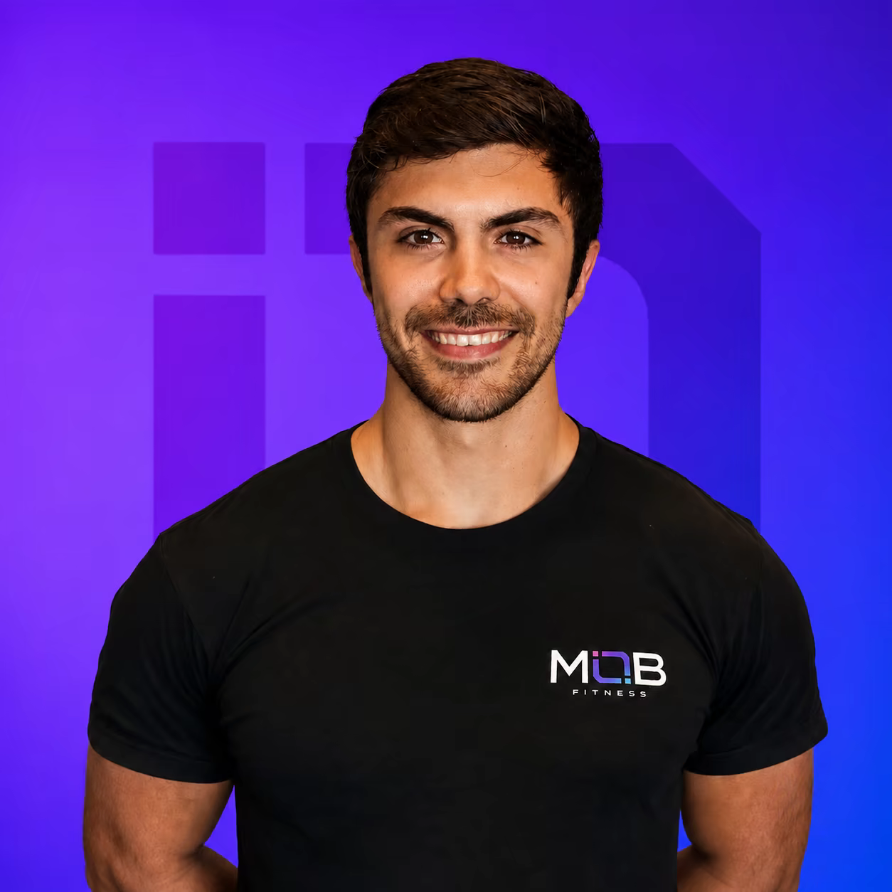 Coach David Gonzalez, owner and head coach at MOB Fitness, wearing a MOB Fitness shirt